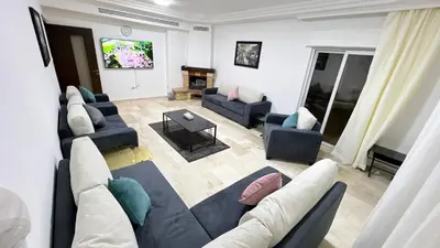 a living room with couches and a flat screen tv at شقة مفروشة اربع غرف نوم عبدون in Amman