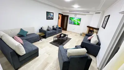 a living room with couches and a tv at شقة مفروشة اربع غرف نوم عبدون in Amman