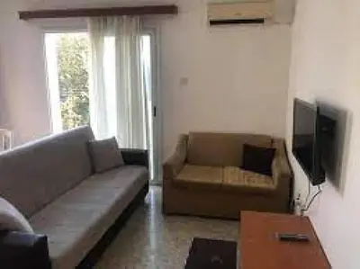 a living room with a couch and a tv at lomez House in Amman