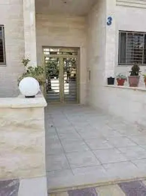 a large building with a lobby with a door at lomez House in Amman