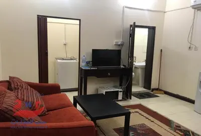 a living room with a red couch and a television at lomez House in Amman