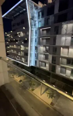 a view of a city at night with buildings at Amman Damac one bedroom boulevard Abdali استديو في داماك عمان الاردن in Amman