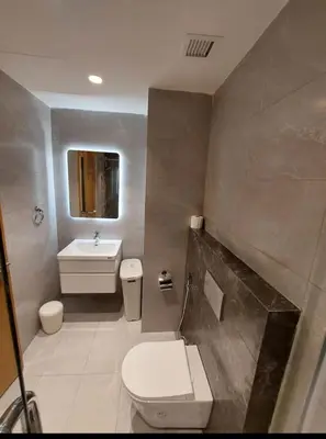 a bathroom with a toilet and a sink at Amman Damac one bedroom boulevard Abdali استديو في داماك عمان الاردن in Amman