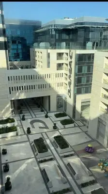 a view of a large white building with a street at Amman Damac one bedroom boulevard Abdali استديو في داماك عمان الاردن in Amman