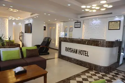 a lobby of a russian hotel with a couch and a table at Hotel Rayshan in Amman