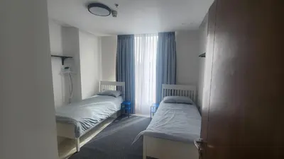 a bedroom with two beds and a window at Amazing new apartment in the middle of Amman in Amman