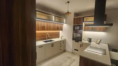 a kitchen with white cabinets and a sink at Amazing new apartment in the middle of Amman in Amman