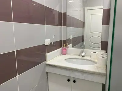 a bathroom with a sink and a mirror at Jordan House INN in Amman