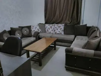 a living room with a couch and a coffee table at 360 INNn in Irbid
