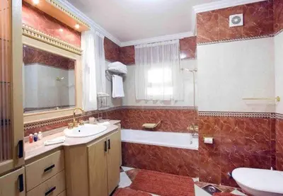 a bathroom with a tub and a sink and a toilet at 360 INNn in Irbid