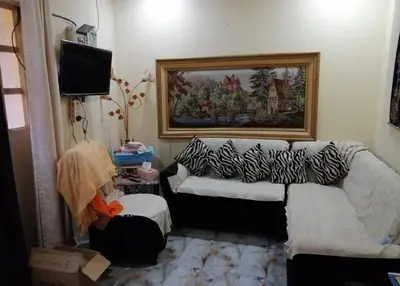 a living room with a couch and a television at 360 INNn in Irbid