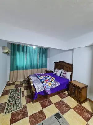 a bedroom with a purple bed and a checkered floor at La bedouin in Amman