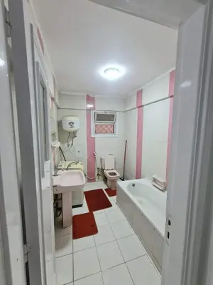 a bathroom with a tub and a sink and a toilet at La bedouin in Amman