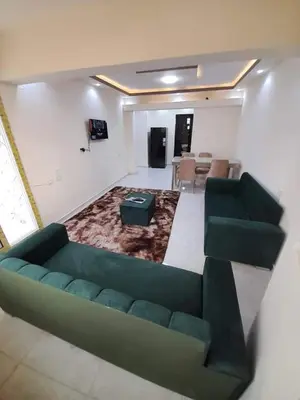 a living room with a green couch and a table at La bedouin in Amman