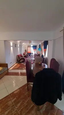 a large living room with a table and chairs at La bedouin in Amman