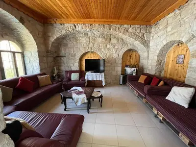 a large living room with couches and a tv at Al Karak House sharing Apt in Kerak