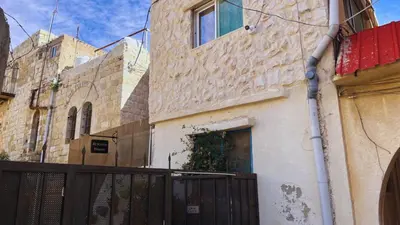 a building with a gate in front of it at Al Karak House sharing Apt in Kerak