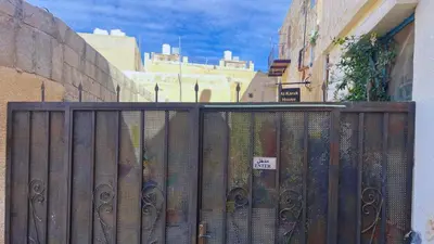 a fence with a bunch of books behind it at Al Karak House sharing Apt in Kerak