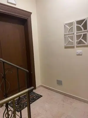 a room with a wooden door and a wall at Sunset Balcony Retreat - Spacious and Comfortable 2 Bedrooms 2 Bathrooms in Amman
