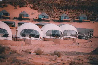 a group of domed buildings in the desert at Fadi camp in Wadi Rum