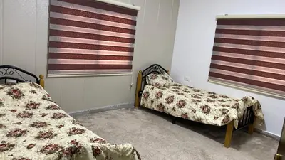 two beds in a room with an american flag at شاليه جبال سوف in Jerash