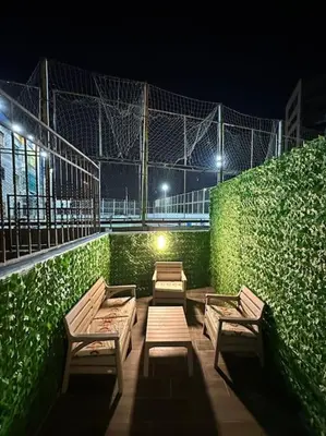 a group of benches on the side of a building at night at Stylish Luxe Apartment F-R 0003 in Amman