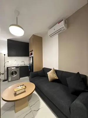 a living room with a couch and a table at Stylish Luxe Apartment F-R 0003 in Amman