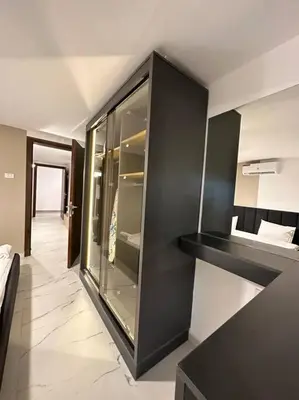 a room with a black cabinet with glass doors at Stylish Luxe Apartment F-R 0006 in Amman
