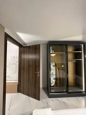 a room with a wooden cabinet and a window at Stylish Luxe Apartment F-R 0006 in Amman