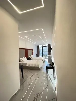 a bedroom with a bed and a desk in a room at Jerash Hotel in Jerash