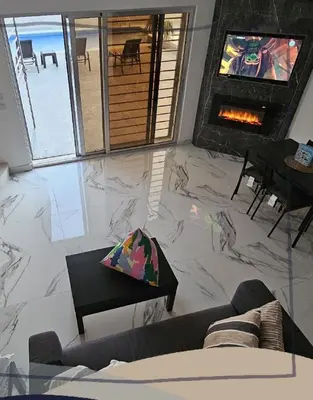 a living room with a couch and a fireplace at Ayla Chalets in Amman