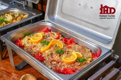 a metal pan of food with orange slices on it at Jad Hotel & Suite in Umm Uthainah