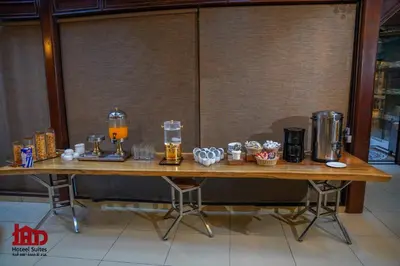 a wooden table with drinks on top of it at Jad Hotel & Suite in Umm Uthainah