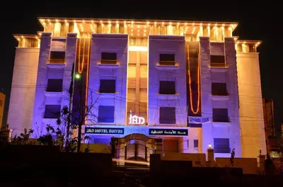 a large building with lights on it at night at Jad Hotel & Suite in Umm Uthainah