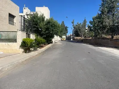 an empty street with trees on the side of a building at Elite Abdoun area, Amman, 2 Br, 5 guests in Umm Uthainah