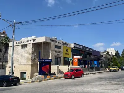 a red car parked in front of a building at Elite Abdoun area, Amman, 2 Br, 5 guests in Umm Uthainah