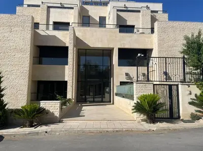 a large brick building with a large glass door at Elite Abdoun area, Amman, 2 Br, 5 guests in Umm Uthainah