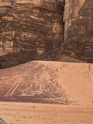 a pile of dirt in front of a mountain at Titanic Wadi Rum in Disah