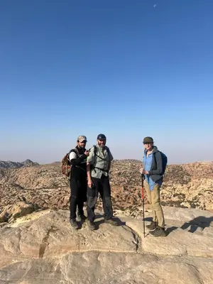a group of three men standing on top of a mountain at Dana horizon hotel in Dana