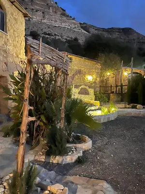 a house with a bunch of plants in the yard at Dana horizon hotel in Dana