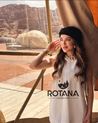 a woman standing in front of a window at Rotana luxury camp in Wadi Rum