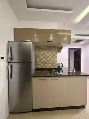 a kitchen with a stainless steel refrigerator in a room at abdoun rooftop 1bedroom kh&sh 03 in Amman