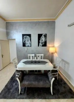 a dining room with a table and chairs in a room at The heart of Jabal alweibdeh 2,000 SF entire apartment in Amman