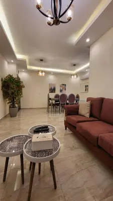 a living room with a couch and a table at Residents Specialists in Amman