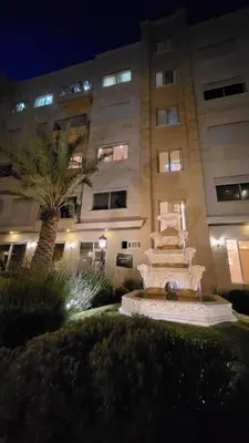 a building with a fountain in front of a building at Residents Specialists in Amman