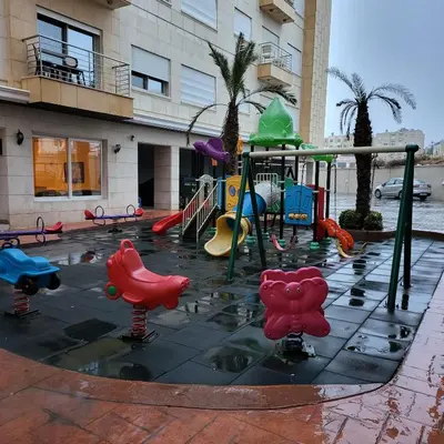 a playground in front of a building at Residents Specialists in Amman