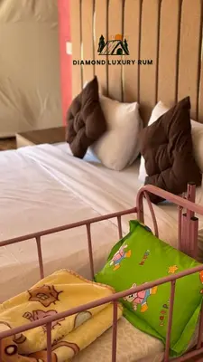a bed with a green bag on top of it at Diamond luxury rum in Wadi Rum