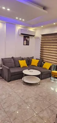 a living room with a couch and a table at 2 bedrooms apartment no 13 in Amman