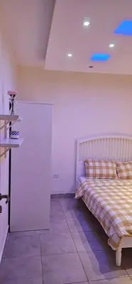 a bedroom with a bed and a white wall at 2 bedrooms apartment no 13 in Amman