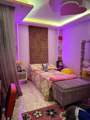 a bedroom with a purple room with a bed and a couch at 3030 Inn in Irbid